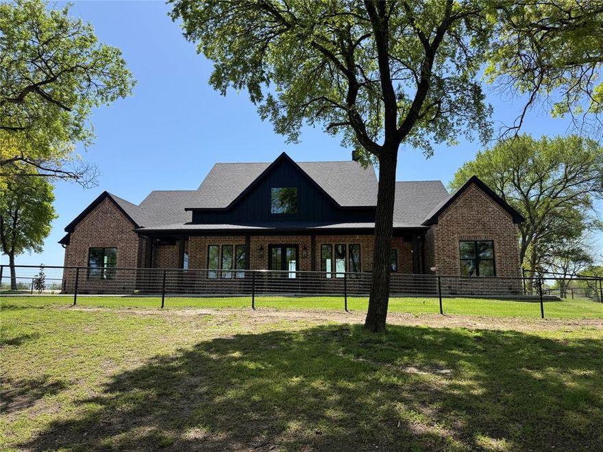 Meticulously maintained hidden gem on 14 acres with two homes. Both custom built homes were constructed with exceptional craftsmanship and thoughtfully designed. The main house was built in 2024 and has 4 bedrooms, 3.5 baths, and a 3 car garage with 8’ tall garage doors. The gorgeous kitchen has tons of counter space and storage. It has quartz counters, full slab quartz backsplash, gas cooktop, and double ovens. The open concept kitchen and living is a beautiful atmosphere for cooking, dining and entertaining. The luxurious primary suite is complete with a beamed vaulted ceiling. The en-suite has two vanities with quartz counters, a freestanding tub, and a walk in shower with full slab quartz walls. Large game room upstairs. Resort style back patio with fireplace and daybed swing. Generac backup on-site if power is ever lost. The secondary home is a stunning barndominium built in 2020 with 3 bedrooms and 2 bathrooms. This has an attached 36’x30’ garage with 2 oversized 12’x12’ garage doors. Both homes boast gorgeous views out every window. Stay connected with high speed fiber internet. Property is fenced with 4’ pipe fencing and has a gated entry. 40’x60’ metal barn with 4 horse stalls. Ag exempt. Located within the highly sought after Van Alstyne ISD. This property is a rare find and gives a mix of both modern luxury and country charm. Come see everything this one of a kind property has to offer!