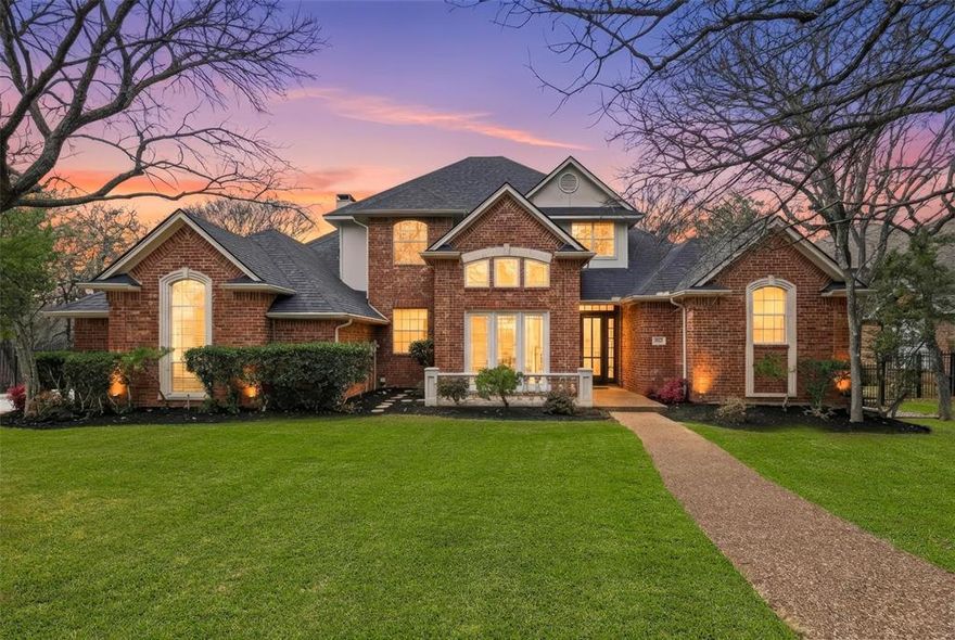 Experience one of the most incredible backyards in Timber Lake. This custom estate is anchored by a show-stopping outdoor oasis, where an expansive outdoor living space framed by elegant wrought iron spans the home’s entire width. Overlooking a sprawling, treed lawn and stone retaining wall, this park-like sanctuary offers a level of seclusion hard to find in newer construction. Inside, the home features the timeless bones of a true classic: rich wood flooring, soaring ceilings, and a layout designed for both grand entertaining and private living. The open-concept kitchen, equipped with granite countertops, double convection ovens, and a center island, flows effortlessly into the living and breakfast areas, while the massive upstairs game room offers a dedicated retreat for family life. The main-floor master suite is a private haven with direct patio access, a jetted tub, and an expansive walk-in closet. A versatile first-floor guest suite (perfect for an executive study), two fireplaces, and a three-car garage complete the picture. Essential updates including a roof replaced in 2022, fresh interior paint throughout, new carpet in all upstairs bedrooms, updated plumbing and light fixtures, and new tile in the upstairs bathroom provide a fresh canvas ready for your modern vision. Located within the coveted Carroll ISD and moments from community tennis & pickleball courts, pools, playgrounds, and trails, this is a rare offering in a prime Southlake location.