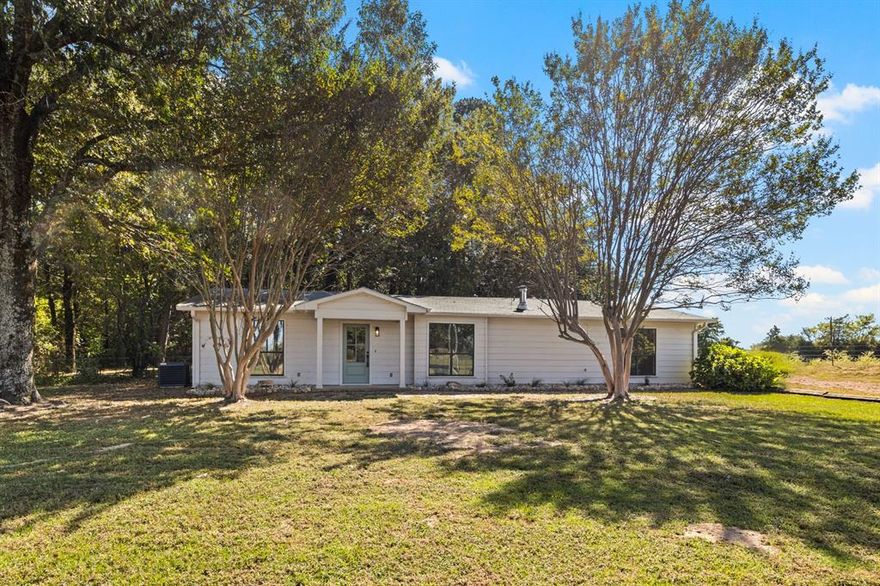 Welcome to your own slice of Texas countryside! This beautifully updated 3-bedroom, 2-bath home sits on a spacious one-acre lot surrounded by peaceful scenery, just minutes from town. With 1,680 square feet of comfortable living space, it perfectly blends classic ranch-style charm with modern updates.

Step inside to find an open floor plan with vaulted ceilings, decorative lighting, and charming laminate and tile flooring throughout. The living room features a cozy freestanding wood stove, creating a warm and inviting atmosphere. The kitchen is a true showpiece with granite countertops, a breakfast bar, and plenty of built-in cabinetry—perfect for family meals or entertaining guests.

The primary suite offers a relaxing retreat with dual sinks, two large walk-in closets, garden tub, and separate shower. Two additional bedrooms share a common hall bath and feature generous walk-in closets for extra comfort and storage.

Outside, enjoy covered front and enclosed back porches, ideal for morning coffee or evening sunsets. The property also includes a two-car carport and a workshop with electricity, great for hobbies or extra storage.

Located in the Harts Bluff ISD, this home offers a quiet country feel with the convenience of being just a short drive from town.