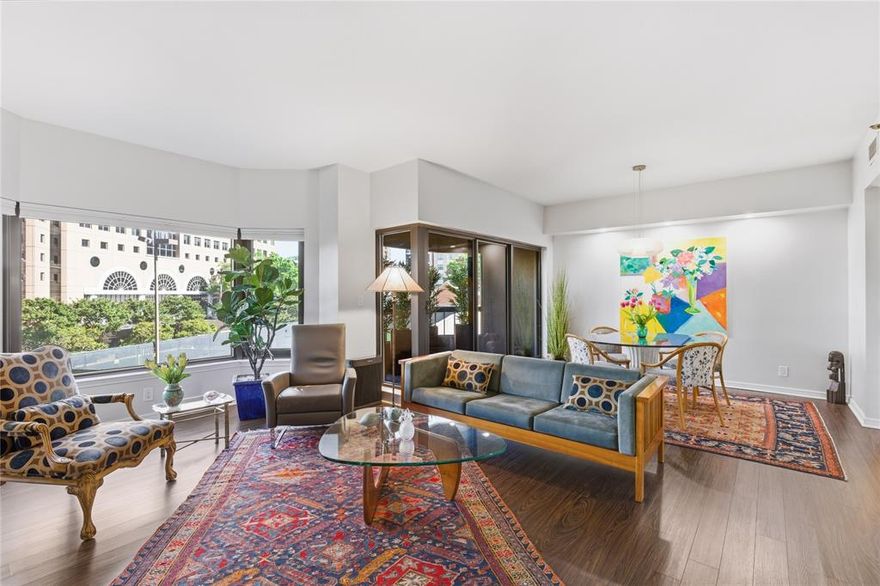 This beautifully updated 2-bedroom, 2-bath residence at La Tour Condominiums offers a rare balance of urban energy and park-like serenity. Surrounded by lush treetop views, the home is filled with natural light from expansive bay windows, creating a calm, elevated atmosphere in the heart of the city.
A proper foyer sets the tone—an increasingly rare feature that creates a true sense of arrival and separation from the main living spaces. Beyond, the open living and dining areas unfold with ease, flowing naturally to a private terrace ideal for morning coffee or evening relaxation. The layout lives like a home, with a distinct bedroom wing that offers privacy and comfort for both residents and guests.
Thoughtfully renovated, the residence reflects quality and refinement throughout. Wide-plank flooring, solid-core doors with Emtek hardware, and a curated mix of Miele and Bosch appliances bring together form and function. Bathrooms are finished with sleek quartz countertops and warm, quarter-sawn wood vanities, creating a clean, modern aesthetic with timeless appeal.
Life at La Tour is defined by service, amenities, and a strong sense of community. Residents enjoy 24-hour concierge, a resort-style pool and spa, saunas, a sunny fitness center, tennis and sport court, firepit, dog park, and an inviting club room for gatherings and events. Dedicated EV charging station at your assigned parking spaces!
Step outside and experience one of Dallas’ most walkable neighborhoods, with a walk score of 98 along McKinney Avenue. Dining, coffee, and everyday conveniences—including Whole Foods Market—are just blocks away, while the nearby Katy Trail offers miles of scenic paths for walking, running, and biking. 
This is a rare opportunity to enjoy the vibrancy of Uptown without sacrificing privacy—an elegant, lock-and-leave residence that truly lives like a home. One of very few units with its own dedicated EV charger!