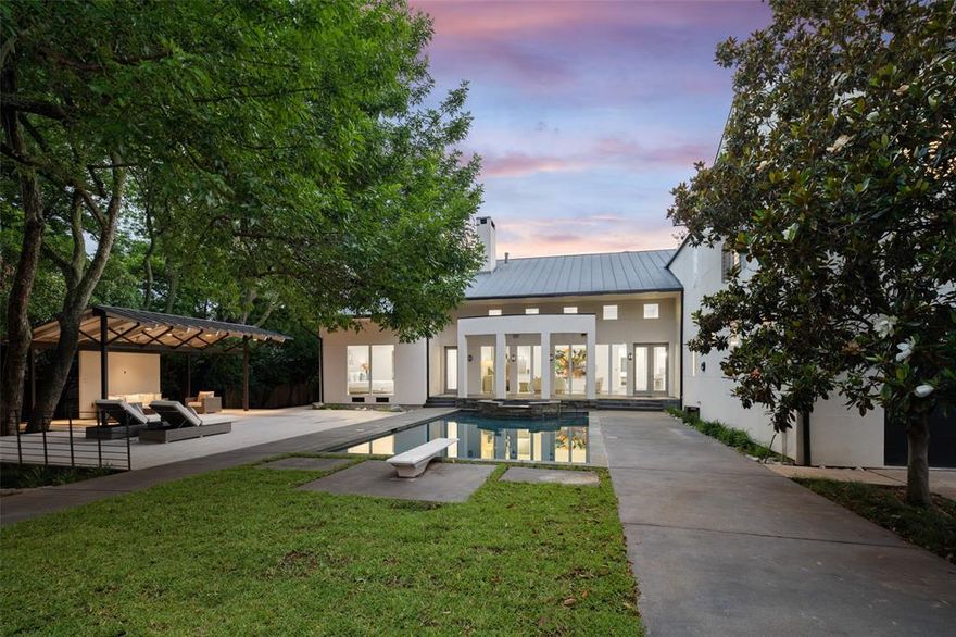 Extraordinary custom contemporary resort style home totally updated and renovated is located on a magnificent heavily treed estate sized corner lot with two private gated entrances. Unique foyer with curved steel staircase opens to the generous dining room, dramatic living and entertaining areas with spectacular views of the pool, pavilion, expansive decks and sophisticated 1000 sq ft cabana. Features include incredible first floor owners suite, exercise yoga space, octagonal study, second floor game room, extra-large bedroom and flex space. Live the luxury lifestyle!