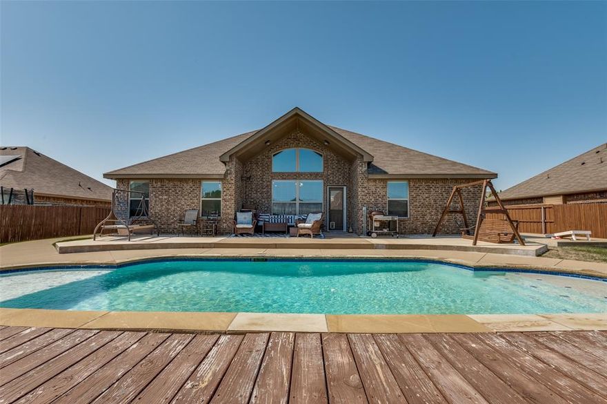 Welcome to this beautifully maintained 4-bedroom, 2-bathroom home, offering the perfect blend of comfort, space, and modern convenience. From the moment you arrive, you'll be drawn in by the home's warm curb appeal—and the real showstopper is waiting out back: a stunning in-ground pool, perfect for summer fun, relaxing weekends, and outdoor entertaining. Step inside to discover a thoughtfully designed split-bedroom layout that provides privacy and functionality for the whole family. The heart of the home is the large kitchen, featuring ample counter space, abundant cabinetry, and room to gather around for meals or casual conversation. The living room offers a welcoming and cozy feel with an electric fireplace, ideal for creating ambiance year-round. Whether you're enjoying a quiet evening at home or hosting guests, this space is both comfortable and inviting. The primary suite is a true retreat, featuring a spacious ensuite bathroom complete with dual sinks, a garden tub, separate shower, and a walk-in closet—everything you need to relax and unwind. On the opposite side of the home, you'll find three additional bedrooms, perfect for family, guests, or even a hobby room. A dedicated office adds versatility for remote work, study, or creative pursuits, making this home suitable for any lifestyle. Step outside to enjoy your own private oasis: a gorgeous backyard with a sparkling pool, perfect for hot Texas days, weekend BBQs, or peaceful evenings under the stars. There's plenty of space for lounging, dining, or adding a garden or play area. This home offers everything you’ve been looking for—space, style, and a resort-like backyard—all in a welcoming neighborhood with easy access to schools, shopping, and more.