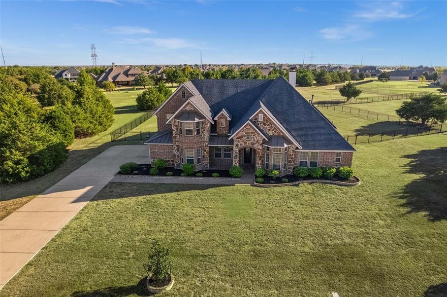 Stunning custom home in sought-after Windsor Place on an oversized lot! Built in 2012, this 4,145 sq ft estate offers 4 spacious bedrooms, 4 full bathrooms, a dedicated home office, a media room, and open-concept living perfect for entertaining. The kitchen features granite countertops, custom cabinetry, a large island, and premium appliances. The luxurious primary suite includes a spa-style bath, walk-in shower, and dual vanities.Enjoy indoor-outdoor living with a covered patio, fully equipped outdoor kitchen, and expansive backyard ready for a pool or play. Additional highlights include hardwood flooring, crown molding, high ceilings, and a separate media room. Located in a quiet, upscale neighborhood just minutes from Lake Ray Hubbard and within easy reach of Dallas.Fresh interior paint, new carpet, and AC units recently serviced.Don’t miss this opportunity to own a private retreat with room to live, work, and entertain.