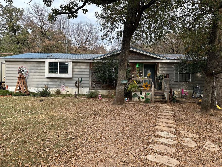 3 bedroom, 2 full baths setting on a beautiful tree covered lot featuring great size workshop garage with attached carport.