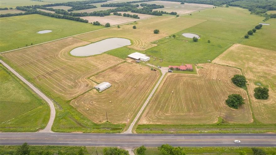 Presenting an exceptional opportunity to become the owner of a remarkable Texas Ranch. This property spans 204.637 acres and features a blend of approx 160 acres of pasture & 40 acres of wooded bottom land. Ideal for those interested in livestock and abundant deer and hog hunting opportunities.  Divided into multiple pastures with four ponds ensuring a reliable water source for your animals. The residence is a spacious with over 2,700 square feet. Boasting four bedrooms, three bathrooms, and two generous living areas, this home offers both comfort and versatility. Additionally, a 40 x 40 metal shop with an attached 80 by 75 covered working pens provides ample storage and workspace. An additional hay barn further enhances the property's functionality and practicality. 

With over 7,000 feet of road frontage, this ranch holds immense potential for future development.

Seize the opportunity to make this Texas Ranch your own.