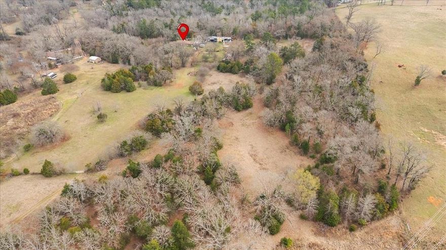 Escape to the peace and privacy of country living! Situated outside city limits, this beautiful 29.3-acre property offers endless possibilities for ranching, recreation, or building your dream homestead. The land is completely fenced, making it ideal for livestock, and features a creek that adds both charm and functionality to the property. The property includes a 3-bedroom, 2-bath home with comfortable living space, ready for you to make it your own. A barn provides excellent storage or livestock shelter, and multiple carports offer covered parking for vehicles and equipment. Whether you're looking to start a small ranch, enjoy wide-open spaces, or invest in acreage with improvements already in place, this property offers the perfect blend of rural tranquility and practical amenities. Don’t miss this opportunity to own your slice of the countryside!