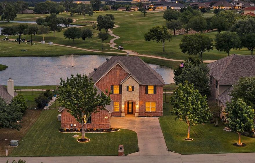 Wake up to shimmering pond views, manicured fairways, and the feeling of living at a private resort every day. Perfectly positioned along the golf course without the worry of stray balls, this beautifully updated 5-bedroom, 4-bath home offers an exceptional lifestyle with Eagle Mountain Lake access inside the gates.

From the moment you step inside, notice this floorplan is designed for connection, entertaining, and easy everyday living. Tranquil views exist in every gathering space on both levels. A bright, modern kitchen remodel anchors the home with clean finishes, generous prep space, and seamless flow into the living or dining areas. Ceramic plank floors, fresh paint, a young roof, and meticulous care create a truly turnkey experience.

The main level primary suite, offers peaceful views of the pond and fairways. Soak in the remodeled bath experience. There's a versatile 2nd suite on the main floor: ideal for guests or as a private office. Upstairs, a spacious game room and dedicated theater create the perfect retreat for movie nights, play space, or hosting. With 3-bedrooms and 2-baths available upstairs, chances are someone may need great schools: Eagle Mountain HS is known for strong academics and championship-level athletics.  

Just 4 houses away: residents enjoy the vibrant infinity-edge community pool, poolside dining service, fitness center, pro shop, playground, and the acclaimed 18-hole championship golf course at The Resort Golf Club. Modern renovations to the clubhouse are expected in 2026, inspired by staging and use in the television series “Landman.” S1,E3.  Keep scrolling to view the community boat launch, marina, gazebos, and a sandy beach with lakeview pickleball, Bball & Wildlife Preserve.  

This home offers a rare combination of lifestyle, flexibility, and resort-inspired living with professionally arranged events. You'll want your own golf cart even if you don't play. The yard is big enough for a pool, too.
