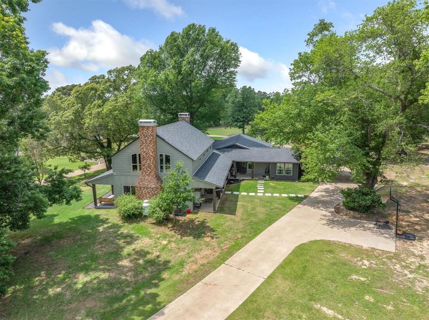 Situated atop a hill in Canton ISD, this remarkable estate offers two updated homes, over eight and a half acres of land, and a detached garage with an efficiency apartment. The property welcomes you in with mature trees that frame the landscape and provide ample shade for the home. The main home showcases boutique finishes with complete remodel in 2023. The stove cove anchors the beautifully designed kitchen, complete with an oversized island ideal for entertaining. Living area features a striking floor-to-ceiling wood-burning fireplace, creating an inviting atmosphere; as the loft area provides additional space for gatherings or a secondary workspace. An office with outdoor access adjoins the primary bedroom, and the expansive front and back porches invite relaxation and enjoyment of the Texas weather throughout the day. The concrete driveway encircling the main home ensures easy access and ample parking. The secondary home includes two bedrooms, two bathrooms, and a two-car garage. Currently rented, this residence offers excellent potential for income or multi-generational living. Adjacent to the second home is a detached garage with an efficiency apartment, adding even more versatility to the property. The property is deed restricted to exclude mobile or tiny homes, preserving its charm and value. Pond on the property adds to the overall enjoyment. Conveniently located on FM 2909 within Canton ISD, this estate combines country living with proximity to restaurants, shopping, and local amenities. The setting, space, and thoughtful design make this property a rare and desirable find in East Texas.
