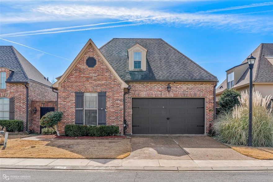 Stunning courtyard home featuring a wrought iron gated entry and a private, welcoming courtyard. The secluded primary suite offers a large walk-in closet and great privacy. Granite countertops shine in the kitchen, baths, and laundry room, complete with a utility sink. Stainless steel appliances, built-in spice racks, and rich wood floors elevate the space. The living room centers around a cozy gas-log fireplace. Enjoy added perks like a security system, sprinkler system, and tons of attic storage. All set in a gated community with sidewalks and a picturesque pond with a water feature.