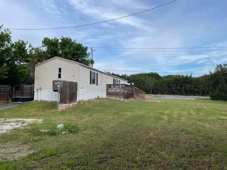Lake community home on 3 lots. HOA has boat ramps 5 minutes from the home at 2 different locations. Plenty of room to park your boat or RV, with a full RV hookup, 50-amp plug-in & septic. Last updated in 2025, including new vinyl plank flooring. New roof replaced with metal. Kitchen has a breakfast bar, all new stainless-steel appliances, new large sink & new faucet.  New low-E Energy Star, lifetime warranty windows, keep your home cool in the summer & warm in the winter. Master bath completely remodeled in 2024, with a walk-in shower, granite vanity top, new sink & new fixtures; extra shower wall tiles are in the 24x14 storage bldg, powered by solar energy. Guest bath has a new vanity, new sink & new faucet last yr.  Seller is willing to convey the following list of items: Washer and dryer, as well as some of the added cabinetry in the laundry area and in the master bath; inside fridge; outdoor freezer, which has a warranty & back-up solar power; home security equipment; wooden hutch against kitchen wall; outdoor gas grill. Front parking is newly paved, as well as the driveway at the back of the property. There are 2 parking entrances to this home. There is an extra-long 24x12 ft carport for a truck or trailer. There are so many extras. The homeowners thought of everything. Front decking was extended to 18x10 ft with additional decking at the back as well. The storm shelter is clean and in good condition. The home & grounds have been very well maintained. The HOA also has 2 different playground locations & 2 different picnic area locations. There is a survey.