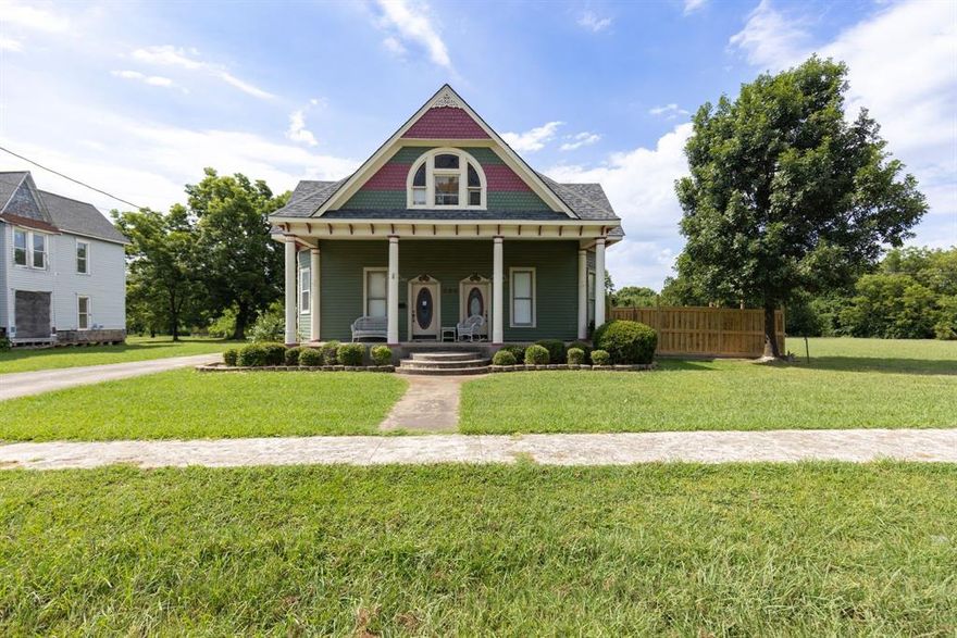 Turn of the century Victorian 3-bedroom 2.5 bath home located in the quaint little town of Ladonia in northeast Texas.  Decorative gabled windows,  gingerbread siding and a large columned front porch give the home timeless vintage charm.  The interior of this character filled home includes, high ceilings, decorative ceiling medallions, original woodwork, ornate windows and crown molding.  An elegant dual  fireplace with the original wood mantle separate the great room and primary bedroom. Though this property is a diamond in the rough upgrades include central HVAC with gas furnace  <5 yrs old, water heater replaced 2022, composite shingle roof 2023 and Privacy fence around main back yard. Can be sold with 406 E Main - Parcel ID 89896 see mls 20667128 for 369K