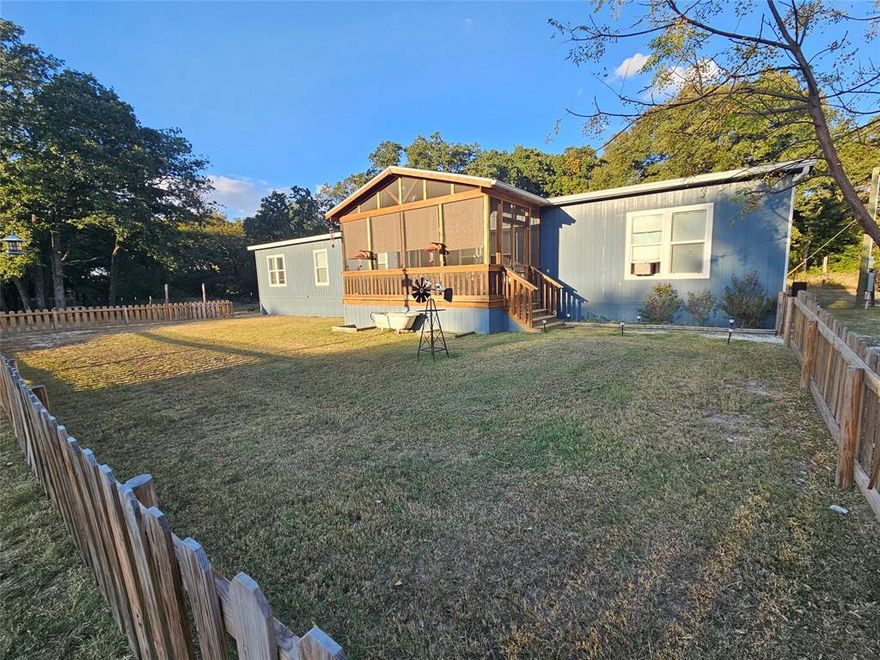 Country home on 2 acres!  This is a like new 4 bedroom and 2 bathroom home built in 2021 by Clayton Homes on a quiet private road near Lake Mexia in Groesbeck ISD located on 2 Acres.  Beautiful home has 2,280 square feet, open floor plan with wonderful kitchen with built ins and a large second living area at the back of the home.  Large, isolated primary bedroom with fantastic attached bathroom with a walk in shower and a great soaking tub! Exterior features include an enclosed screened in front porch, huge covered back porch some fencing and more!  Nice sized detach workshop with potential to be converted to additional living space.  Should qualify for all types of financing!