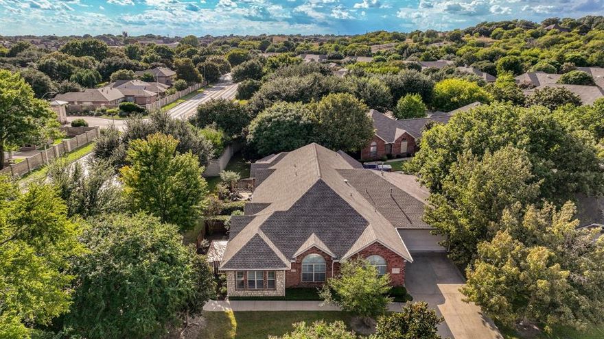Behind the gates of River Bend Villas, tranquility meets timeless design. This inviting townhome offers more than just square footage—it’s a place to feel centered and at home. Tucked among mature trees and manicured landscaping, the community feels like a quiet escape in the heart of Fort Worth. Step inside and discover a layout that lives like a single-level retreat—everything thoughtfully arranged on one floor, from the living spaces to the attached garage, offering ease and accessibility that’s hard to find in townhome living. The kitchen anchors the home with rich cabinetry, granite countertops, and under-cabinet lighting that elevates everyday cooking. The spacious primary suite provides a peaceful retreat with a full bath and granite-topped vanity, while the second bedroom offers versatility for guests, work-from-home needs, or extra living space. A dedicated office with a built-in desk adds both function and polish, perfect for remote work or creative pursuits. The sunroom, filled with natural light, seamlessly extends the living room and transforms into a welcoming space for special occasions or quiet reflection. Plantation shutters frame every window, hardwood floors and ceramic tile add classic elegance, and vaulted ceilings create an open, airy feel. A cozy fireplace invites relaxed evenings, and the private garden patio—shaded by graceful trees—sets the scene for morning coffee or weekend unwinding. River Bend Villas isn’t just a place to live—it’s a place to feel at ease.