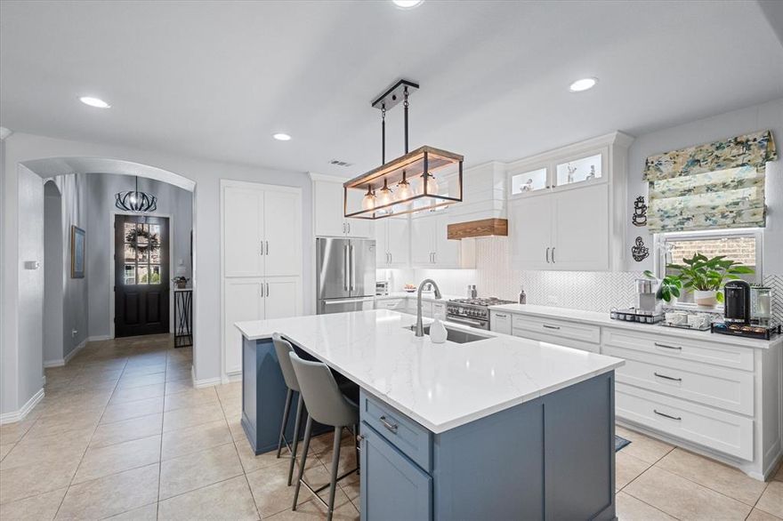 Step into the heart of this Viridian home and discover a chef-inspired custom kitchen, completed in January 2023. Designed for both beauty and function, it boasts upgraded Bosch appliances, sleek custom cabinetry with pull-out pantry drawers, and an oversized island that invites gatherings and culinary creativity. Every detail—from the premium finishes to the abundant storage—was thoughtfully chosen to elevate everyday living and entertaining. This stunning 4-bedroom, 3-bathroom residence flows seamlessly from the kitchen into the dining and living areas, where a cozy fireplace creates a warm focal point. The first-floor primary suite offers a spacious ensuite bath, complemented by two secondary bedrooms and a full bath. Upstairs, a versatile flex room provides endless possibilities—game room, office, or media space—alongside an additional bedroom and full bath. Outdoor living is equally inviting with a covered patio and a freshly re-sodded, low-maintenance backyard perfect for relaxation or entertaining. Updated fixtures throughout add a touch of modern style, completing this thoughtfully designed home in the vibrant master-planned community of Viridian. Living in Viridian means access to resort-style amenities including pools, tennis and pickle ball courts, parks, trails, and lakes, all within a highly sought-after community just minutes from shopping, dining, and entertainment with easy access to Hwy's 183, 360 and I-30. Modern comfort and community - what more could you ask for? THIS HOME QUALIFIES FOR GRANT PROGRAMS OFFERING UP TO 2.5% OF LOAN VALUE IN CLOSING COSTS!