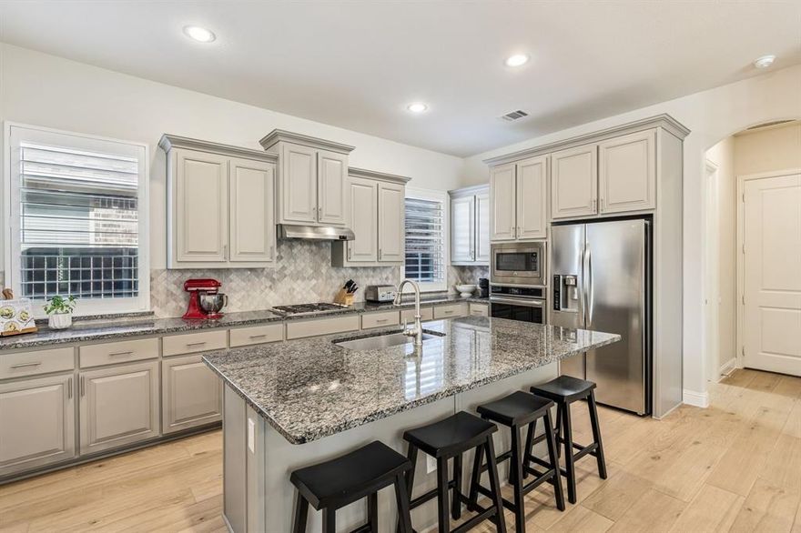 Located in the Berkshire community of Fort Worth Texas in Tarrant County and zoned to Northwest ISD, this 4 bedroom, 3 bathroom residence offers approximately 3,182 square feet of two story living built by K. Hovnanian Homes in 2016. Positioned near Highway 287, Blue Mound Road and Interstate 35W, Berkshire in Fort Worth provides convenient commuter access toward the Alliance Corridor and Downtown Fort Worth while remaining minutes from Alliance Town Center and Presidio Towne Crossing. Designed for open concept functionality and flexible gathering space, the floor plan connects the kitchen, dining and main living area to support everyday living and entertaining. The primary suite includes dual sinks, granite counters, separate shower and walk in closet space creating a private retreat within the home. Secondary bedrooms are arranged to balance shared areas with personal space. If you are searching for 4 bedroom homes in Fort Worth Texas within Northwest ISD near Alliance, this layout supports both daily functionality and long term value. Interior updates include premium wood look tile flooring installed in 2025, plantation shutters and tall ceilings that enhance natural light throughout the home. The upstairs game room offers a separate activity space with multiple windows and abundant natural light. The main living area is anchored by a gas fireplace with tile surround and decorative mantel while the kitchen features under cabinet lighting, generous cabinetry and an open layout designed for gatherings. Extensive storage includes large bedroom closets and additional hallway storage. Outdoor living extends to a covered patio with added pavers for grilling and entertaining. Community amenities in Berkshire include a pool, playground, clubhouse and walking trails. This property presents a balanced combination of layout versatility, Northwest ISD zoning and established Berkshire positioning within the north Fort Worth Texas market.