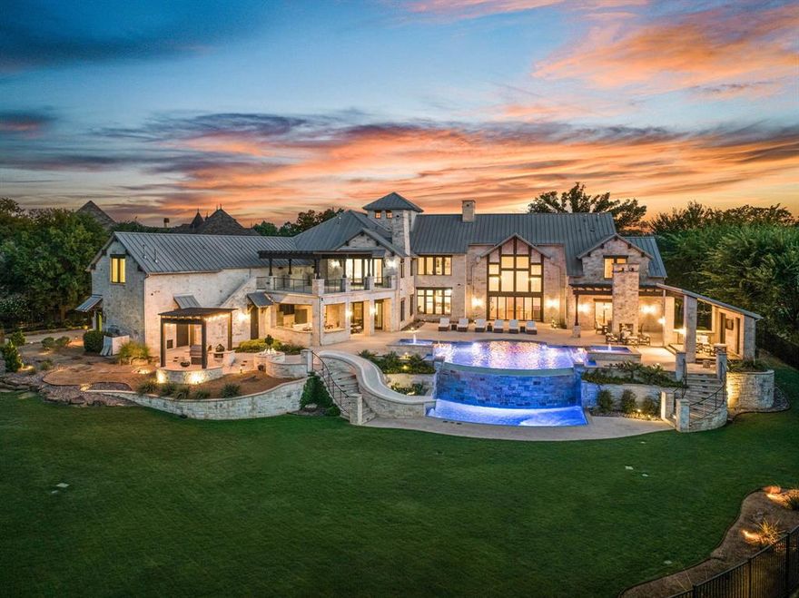 EXQUISITELY crafted Westlake Estate, nestled against a picturesque backdrop of protected Engineers Corp land. Located in gated Terra Bella, this timeless transitional style home is a masterpiece of design, boasting architectural brilliance and meticulous attention to detail. Step inside to discover a world of sophistication, with stunning interior finishes that include 125 year-old reclaimed wood plank floors, elegant Carrara marble, and exquisite Murano glass light fixtures. Indulge in a chef's dream kitchen equipped with top-of-the-line Subzero and Wolf appliances, and a spacious island perfect for family gatherings. Luxurious Master suite, with his and her vanities and free standing tub showcasing exquisite marble detailing throughout. Discover an outdoor oasis that includes a luxurious resort-style infinity edge pool, multiple entertaining areas, dual spas, a thrilling water slide leading to the lower level pool, and a cozy fire pit. Choose CISD or acclaimed Westlake Academy.