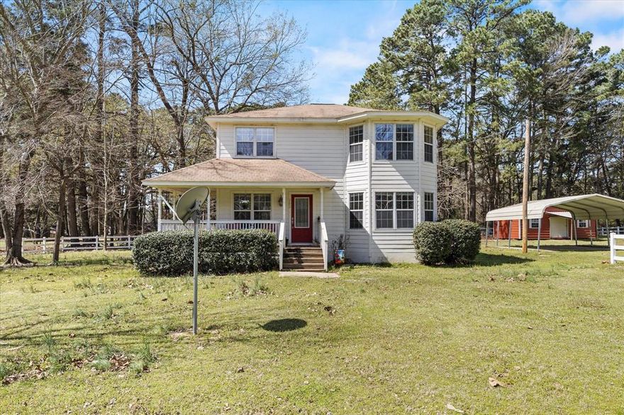 Peaceful property with wrap around porch and across from Walleye Park.  Corner double lot with a white rail fence surrounding.  This beautiful property offers 1,647 SF of spacious living.   Step inside to find a generous living and dining room perfect for family time and lake living.  Features 4 bedrooms and 3 full bathrooms. Lots of windows and natural light for this relaxing resort. Outside enjoy the sizable wrap around deck.  Perfect for outdoor gatherings, cookouts or tranquil mornings with a cup of coffee.    Features a 21 x 20 carport sitting on over half an acre.  Also a metal shop storage building that measures 26 x 14.  Within walking distance to the lake with accessible boat ramp.  (Refrigerator to convey with the house)