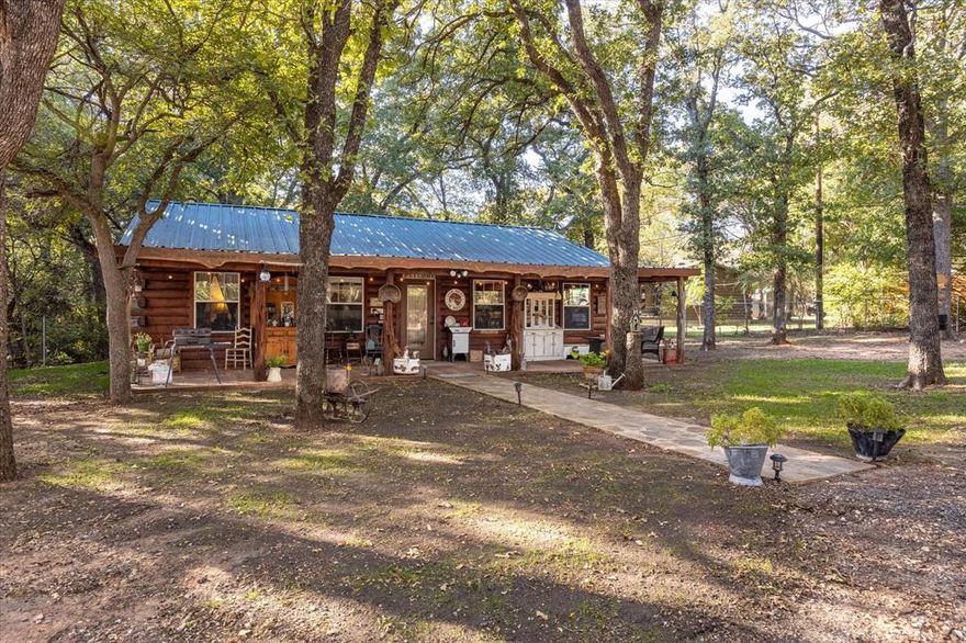 Welcome to your very own retreat nestled among 3 generously wooded lots. This property offers the ideal escape from the hustle and bustle of daily life.  It is perfect for year-round living or a serene weekend get-away.  This 3 bedroom 2 bath log cabin with metal roof offers you perfect blend of comfort and serenity.  Experience nature on your covered front porch while enjoying a morning cup of coffee or grilling a delicious meal.  A short 5 minute drive to enjoy all that the beautiful Lake Granbury has to offer, and only minutes from downtown where you will find shopping and dining.  Don't miss out on making this picturesque log cabin your very own personal haven.