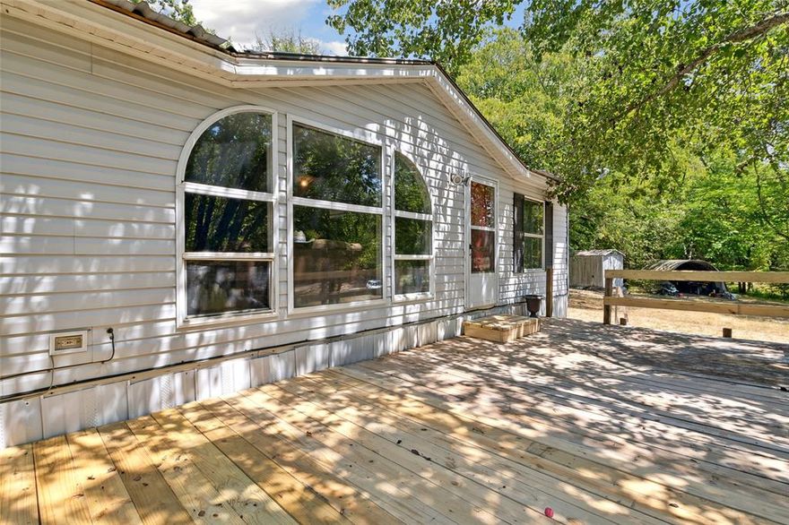 Discover a slice of Texas paradise in the heart of Yantis. Situated on 1.8+ acres of picturesque, treed land, this charming home offers a serene escape in a peaceful area with the occasional deer sighting. As you step inside, you'll be greeted by natural light pouring in through the large living room window. The kitchen and bathrooms boast granite countertops, elevating the aesthetic and functionality of these spaces. A standout feature is the metal roof, thoughtfully replaced in 2020, providing durability and peace of mind during every season. Step outside onto the sprawling front porch that spans half the length of the home, inviting you to enjoy the fresh air and unobstructed views. This expansive outdoor space is perfect for moments of relaxation, entertaining, and taking in the beauty of the land. Don't miss your chance to own this wonderful property!