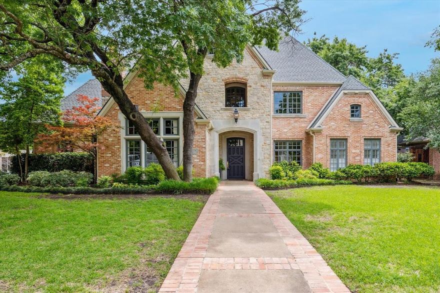 Discover timeless elegance and modern luxury in this beautifully renovated Preston Hollow home, set on over one-third of an acre surrounded by mature trees. Designed for both comfort and sophistication, this residence blends classic charm with contemporary updates and an open-concept layout.Step into the grand foyer with its striking staircase, iron balusters, and sisal-covered steps. Gleaming hardwood floors lead to a stylish living room featuring the first of two fireplaces. The formal dining room, with plantation shutters and lush front yard views, sets the stage for refined entertaining. The gourmet kitchen is a chef’s dream—highlighted by soapstone countertops, glass-front cabinetry, a built-in wet bar with wine chiller, farmhouse sink, double ovens, two dishwashers, and a high-capacity gas cooktop. A large island offers prep space and casual dining, while a custom walk-in pantry provides ample storage. The sunny breakfast nook overlooks the resort-style backyard with pool, spa, grilling station, and lush landscaping—perfect for outdoor living. The light-filled great room features floor-to-ceiling windows and a second fireplace. Just off this space, a spacious office or library with custom shelving offers privacy and flexibility. Two well-placed half baths serve both guests and pool-goers.
The serene primary suite boasts a wall of windows, a cozy sitting area, and a spa-like bath with whirlpool tub, separate shower, and dual walk-in closets. Upstairs, accessed by two staircases, are three oversized en-suite bedrooms and a generous game room. This exceptional home offers luxurious living, quality craftsmanship, and indoor-outdoor elegance in one of Dallas’ most prestigious neighborhoods.