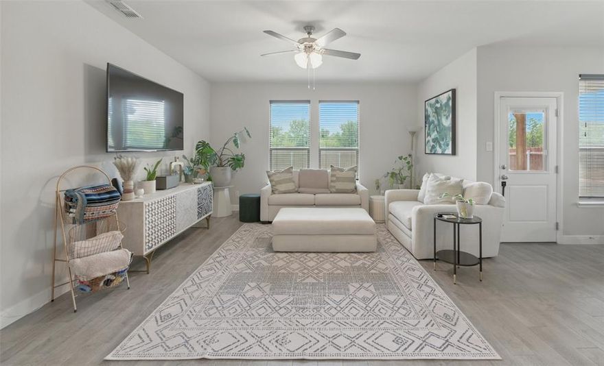 Sophisticated, spacious, and private, this 3 yr old home in the Trails of Elizabeth Creek has a greenbelt on two sides. Great location in Northwest ISD, just west of I35 and 114 with new neighborhood elementary down the street as well as community pool, clubhouse, parks, trails and pond. Pleasing neutral palette begins with light wood tone ceramic tile throughout the home, beautifully contrasted with fresh white cabinets and quartz and granite counters. You will love the luxurious look and feel of wood with the durability and easy care of tile. Excellent floor plan features a large kitchen flowing seamlessly into the living and dining, and all overlooking the backyard and natural area behind. Island Kitchen with separate beverage bar has a gas range, a breakfast bar, an abundance of counter and cabinet space and a walk in pantry. Two bedrooms are at the front of the house, with a bath in between, and a third bedroom, currently an office, opposite. The primary suite is spacious and bright with large ensuite bath and huge customized closet. Backyard has an oversized covered patio with custom pergola, nestled in the prairie that stretches for miles beyond the fence. Owned solar panels, power bank and tankless water heater convey with purchase and ensure low utility bills.  Average monthly electric bill is an astonishingly low $81!