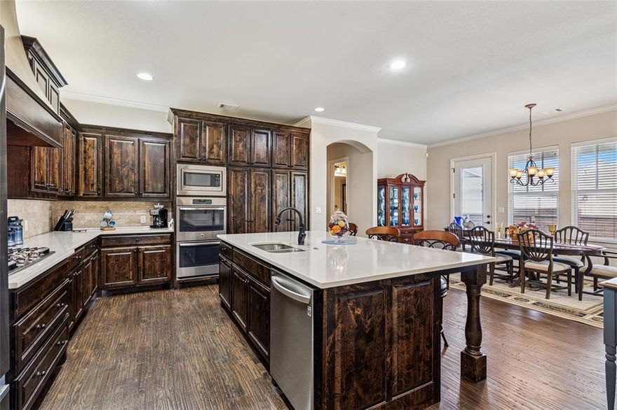 Discover the charm of Hometown living in this beautifully crafted custom home, built in 2017. Located in the highly desirable Villas of Hometown of North Richland Hills, this 3-bedroom, 2-bath property offers an inviting open-concept layout designed for comfort and style.
A welcoming front porch leads you inside, where the living room, dining area, and gourmet kitchen blend seamlessly together. The living room features a warm fireplace and a striking beam-accented tray ceiling, while the kitchen stands out with its high-end finishes, modern appliances, and thoughtfully designed layout—perfect for everyday living or entertaining guests. A built-in desk nook provides a convenient space for remote work or study.
The spacious primary suite serves as a private retreat, complete with dual vanities, a deep garden tub, a separate shower, and an oversized walk-in closet. Step outside to enjoy the covered side patio, ideal for unwinding in the evenings or hosting gatherings year-round.
Residents of Hometown enjoy an exceptional lifestyle with access to peaceful ponds and fountains, scenic walking and biking trails, lush parks, charming gazebos, and unique art installations throughout the neighborhood.