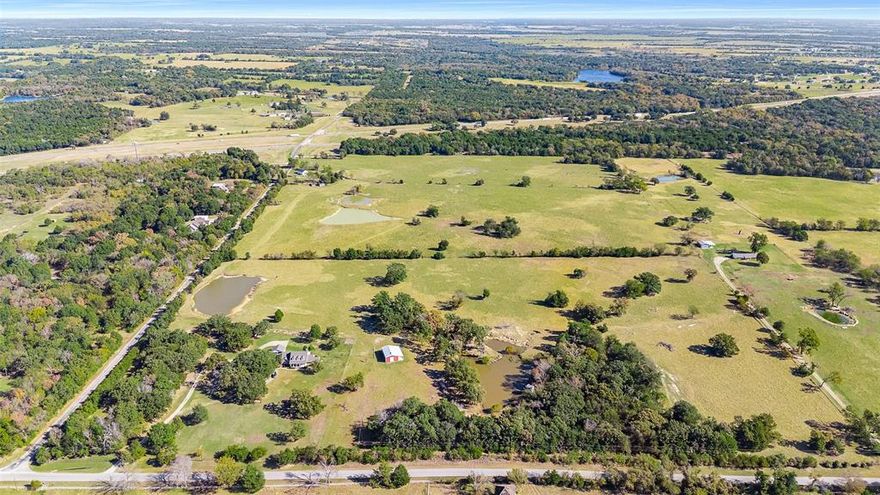 37.38 Acres with Two Stocked Ponds, 50x30 Shop, and Over 2,300 Ft of Road Frontage — Minutes from I-20! Discover the perfect blend of privacy, functionality, and location with this stunning 37.38-acre property just 1.2 miles from Interstate 20, offering easy access to Dallas (42 mi), Terrell (12 mi), and Tyler (58 mi). The beautiful custom ranch-style home welcomes you with timeless charm — a wide front porch, classic dormer windows, and inviting curb appeal. The roof was replaced in December 2023, adding peace of mind for years to come. Inside, you’ll find open and comfortable living spaces designed for everyday living and entertaining. Outdoors, enjoy two picturesque ponds stocked with catfish, perfect for fishing or relaxing by the water. A 50x30 shop with an additional 50x12 covered area provides plenty of space for vehicles, equipment, or projects. With approximately 2,350 feet of road frontage, this property offers both accessibility and potential for future use. The land itself is a beautiful mix of open pasture and mature trees, ideal for livestock, recreation, or expansion. Whether you’re envisioning a private ranch, family homestead, or weekend retreat, this property has it all — wide-open skies, peaceful surroundings, and unbeatable convenience. Experience the best of country living — serene, spacious, and conveniently close to the city.