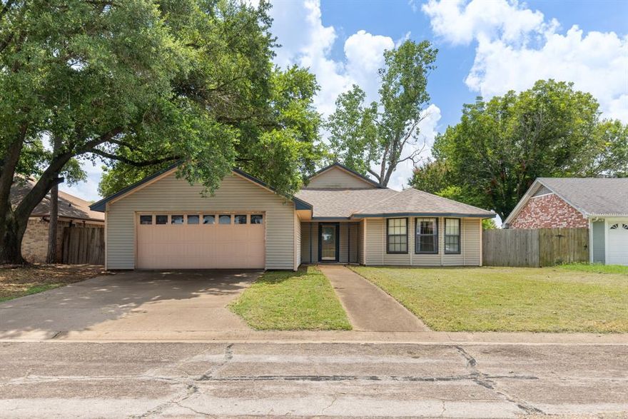 Tucked beneath mature shade trees on a quiet cul-de-sac street, this single-story home offers space, light, and a layout that just makes sense. The brick fireplace anchors the living room with warmth and charm, and a vaulted ceiling with a rustic beam overhead adds just the right touch of character. The kitchen offers generous cabinet space, a practical layout, and a spot to gather around the table for easy weeknight meals.
The floor plan flows easily, with three bedrooms and two full baths, including a bay-windowed front suite. The backyard offers a little elbow room with a patio tucked under the trees—just enough for a firepit, a grill, or a moment of peace at the end of the day.
Located just east of Waco Mammoth National Monument, you’re only minutes from I-35, big-box shopping, restaurants, and medical facilities, but still tucked into a neighborhood that feels pleasantly removed from it all. Located in the highly regarded Bosqueville ISD.
This home has been lived in, loved on, and has more chapters ahead.