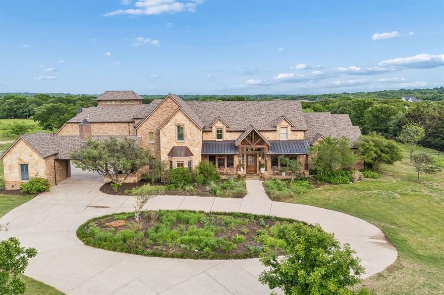 Some homes just feel different the moment you turn down the drive.
4088 Chimney Rock is that home. Perched on 10 private acres in one of Flower Mound's most coveted corridors, this Texas Hill Country estate was built in 2004 with materials most homes will never have. The reclaimed timber trusses in the great room came from 1830s-era log houses near Old Fort, North Carolina. The pecky cypress walls were milled from century-old logs recovered from a Florida riverbed. The American chestnut mantel spent 60 years submerged in a North Carolina creek before making its way to Texas. You just cant buy this at the lumber yard.
The craftsmanship runs throughout. A barrel-vault entry, two-story window wall, stone fireplaces, chef's kitchen with pro gas range and prep space to spare, primary suite with spa bath and walk-in shower. Every room built to last.
Then step outside. A resort-style pool with rock waterfall, beach entry, and spa anchors a flagstone patio made for living. The covered outdoor kitchen with bar seating, built-in grill, and large TV flows seamlessly to the fire pit and open yard beyond. Two upper decks look out over the pool, the pond, the barn, and miles of unobstructed North Texas sky. On a clear night, the views stretch to the horizon. The stargazing room on the third level was built for exactly that.
Zoned to top-rated Flower Mound High School in Lewisville ISD. Minutes from dining, shopping, and DFW Airport.