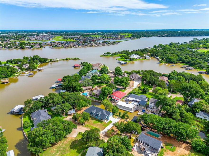 Discover lakeside living at its finest in this stunning newly built waterfront home on Lake Granbury! With over 2,000 sq ft of beautifully designed space, this 3-bedroom, 2-bath retreat combines luxury, comfort, and breathtaking views. Step into the oversized kitchen—truly a showstopper—with custom cabinetry, sleek quartz countertops, stainless steel appliances, and a massive island that's perfect for entertaining. The open-concept living area includes a cozy sitting or reading nook, ideal for relaxing with a view. All three bedrooms are generously sized and feature walk-in closets and ceiling fans. Two of the bedrooms even offer direct access to the lakefront—wake up to the water every day! The primary suite is a true sanctuary with a spa-inspired bathroom: a freestanding soaking tub, spacious tile shower, double vanities, quartz counters, and a private toilet room. There’s even potential to expand with attic space ready to be finished into a media room, game room, or extra bedroom. But the crown jewel? A massive wraparound porch offering panoramic lake views from every angle. Whether you're sipping coffee in the morning or relaxing in the evening shade (yes—the sunsets are on the other side!), this porch is pure paradise. Waterfront homes like this are rare—don't miss your chance to own a slice of lake life luxury!