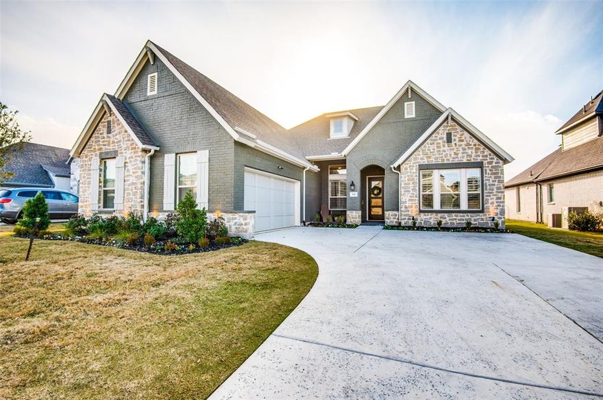 With designer touches throughout, you don't want to miss this stunning David Weekley home. Finished in 2022 and meticulously cared for this spacious & comfortable home features a highly desired split floor plan design with 2 ensuites. An entertainers and chefs dream, this open concept kitchen, living  and dining area has stacked floor to ceiling cabinets, custom built ins, extensive countertop space, farmhouse sink, built in wine rack and wine fridge plus so much more! Avoid the after school back pack clutter and drop everything in your built in drop zone. Master suite has huge walk in closet, dual sinks, walk in shower plus a rain shower head. Your guest will love their private ensuite. Clean up is easy with your engineered hardwood flooring in all living areas and designer tile in the bathrooms. Custom lighting and and fixtures throughout, extended covered patio. The best way to describe this home is upgrades, upgrades, upgrades.