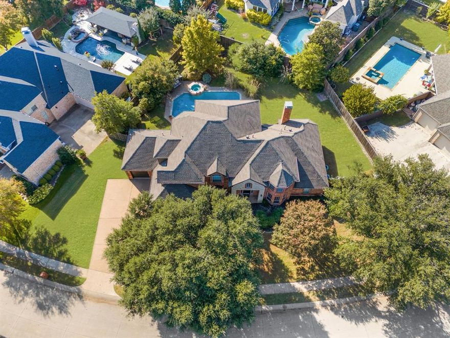 Welcome to this custom-built, original-owner home located in a second-to-none neighborhood within Stonebridge Ranch. Partial lake view with catch and release fishing only steps away. This elegant property offers timeless construction with 100% brick exterior, mature oak and crepe myrtle trees. The private backyard features a beautifully renovated foley diving and lap pool, size 38 x 18 x 10 ft. deep. View the serene backyard from the breakfast nook and patio. The home has a primary down and a second bedrm or office down with full bath next to it. 3 bedrooms up with LA. Two attached garages—a 2-car garage and a 1-car garage—provide exceptional storage and parking flexibility. Inside, the home underwent extensive updates, including full interior paint, new flooring throughout most of the rooms (hardwood, tile, and carpet), window blinds downstairs, and updated kitchen finishes such as leathered granite countertops, stainless steel appliances, shiplap island, backsplash, and hardware on all cabinetry. The primary bath was refreshed with new paint, faucets, toilets, and hardware. Additional features include two fireplaces (living room and primary bedroom), a wet bar off the living room, and a utility room plumbed for a sink with space for an additional refrigerator. Mechanical updates include two water heaters, roof in 2017, underground sprinkler system, downstairs HVAC replaced in 2012, and the upstairs HVAC replaced in 2015. Exterior improvements include fresh exterior paint in 2025 and solar landscape lighting. The pool was fully redone in 2024 with pebble, plaster, travertine, spa enhancements, $2,000 in LED lighting, stabilized skimmers, and an auto filler. Artificial boxwoods are placed outside the dining room window. Stonebridge Ranch offers unmatched amenities, including the Aquatic Center, sports courts, numerous playgrounds, lakes, greenbelts, and strong community appeal. This home delivers an exceptional blend of quality, privacy, location, and lifestyle.