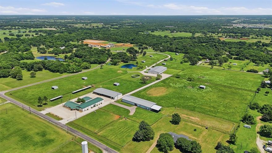 A rare offering for the serious equestrian professional or investor—this premier, turnkey equestrian estate and breeding center delivers scale, functionality, and versatility across 29.3 pristine acres in a highly desirable location. Purpose-built for high-capacity boarding, elite breeding operations, and year-round training, the facility features 38 stalls and a thoughtfully integrated layout designed to support a full-service equine enterprise. Whether you’re expanding an established program or launching a top-tier operation, this property provides the infrastructure to perform at the highest level. 5-Stall Barn: Five oversized 14’ x 14’ climate-controlled stalls, dedicated storage, and a 39’ x 24’ covered area—ideal for premium boarding or specialized care. Mare Motel:  The Breeding Hub, Ten 11’ x 14’ stalls, two 17’ x 13’ isolation stalls, breeding stocks, and a 50’ x 56’ covered lunging area. Show Barn: Nineteen 11’ x 14’ stalls, and a specialized 20’ x 14’ foaling stall, breeding stocks, and electric fold-up doors to maximize airflow and comfort. Arena Barn: Training & Lab Complex. A 60’ x 152’ indoor arena anchors this versatile space, complimented by a dedicated collection area, full-size laundry, half bath, and multiple office or tack rooms. Outdoor amenities include a 6-horse electric walker, 50’ round pen, six expansive pastures with loafing sheds, and three large paddocks—each equipped with 58’ x 10’ covered areas. At the heart of the property, a modern 2-bedroom, 2-bath residence offers comfortable, stylish living. The open-concept design features a chef’s kitchen, a spacious living area, and flexible bonus rooms ideal for a home office, trophy room, or guest accommodations.  Perfect for an owner-operator or on-site manager. This is more than a property—it’s a fully realized equine enterprise with exceptional potential for growth and customization. Opportunities of this caliber are seldom available. Schedule a private tour to experience it firsthand.