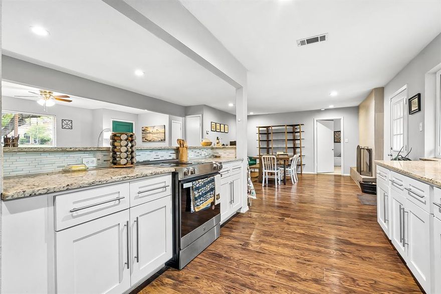 If you have longed for the chance to have a little wilderness in your backyard, to live with the convenience of the city but the charm of nature, to step out the back gate and find an adventure, this delightfully updated home on a quiet friendly street with a spacious tree-shaded backyard may be exactly what you were dreaming of. Rather than having to live with a tiny backyard, with multiple neighbors peering over the back fence from their 2-story homes, try this instead: walk across your spacious backyard with almost a third of an acre, through the back gate, under the trees, and find yourself in a little canyon, where wildlife roam and hawks soar. Follow the trail to the lake, or head the other direction to Big Fossil Creek and miles of adventure.
When you come back to the house, relax in front of the fireplace in the elegant den living area. Step into the impressively remodeled kitchen, or down the hall to the secluded office. Every room has been updated for maximum enjoyment here.