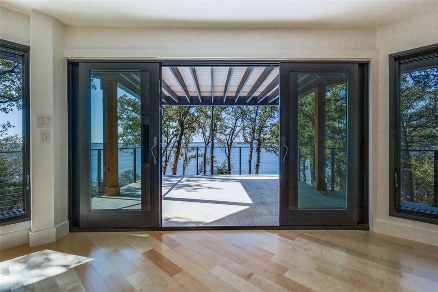 Truly spectacular tri-level lakefront home featuring gorgeous big open water views from nearly every room. This home has recently been completed & includes cutting edge technology throughout. From the induction cooktop to the 5 built in WiFi extenders, this home has all the bells and whistles! Beautiful design is featured everywhere you look and the lot is very private.  You will love the low maintenance exterior: fire resistant siding, metal roof custom iron door designed to mimic the roofline & TimberTech decking. Top of the line appliances & thoughtful kitchen designs such as a hidden coffee station. The lighting in this home is outstanding, especially the LED lighting on the floating steel and maple open staircase. Hardwood floors throughout, quartz countertops, EV charger, and each bathroom features a different geometric shape. You will never find another home exactly like this one! Many energy efficient features as well such as completely foam encapsulated, UV sterilizer and water filtration system, 21 SEER AC system, mechanical room and concrete bunker for both storage and storm shelter. Located near the Yacht Club and the Polo fields, Fox Hollow is a lovely community featuring 40 acre green space buffer at the front of the neighborhood. Close to Little Elm, Frisco, the DNT and I-35. New construction on the lake is hard to find. If you have been wanting lakefront, do yourself a favor and come see this masterpiece quickly!