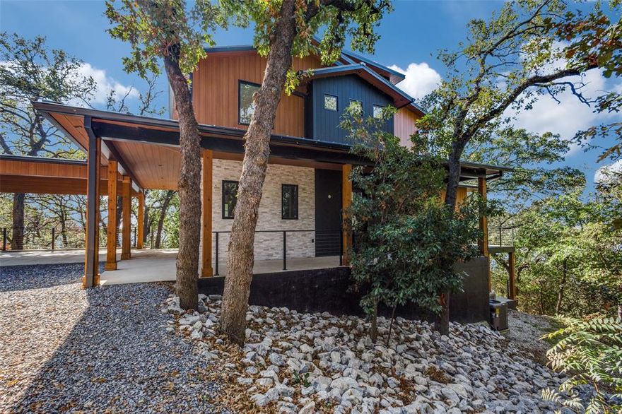 Truly spectacular tri-level lakefront home featuring gorgeous big open water views from nearly every room. This home has recently been completed & includes cutting edge technology throughout. From the induction cooktop to the 5 built in WiFi extenders, this home has all the bells and whistles! Beautiful design is featured everywhere you look and the lot is very private.  You will love the low maintenance exterior: fire resistant siding, metal roof custom iron door designed to mimic the roofline & TimberTech decking. Top of the line appliances & thoughtful kitchen designs such as a hidden coffee station. The lighting in this home is outstanding, especially the LED lighting on the floating steel and maple open staircase. Hardwood floors throughout, quartz countertops, EV charger, and each bathroom features a different geometric shape. You will never find another home exactly like this one! Many energy efficient features as well such as completely foam encapsulated, UV sterilizer and water filtration system, 21 SEER AC system, mechanical room and concrete bunker for both storage and storm shelter. Located near the Yacht Club and the Polo fields, Fox Hollow is a lovely community featuring 40 acre green space buffer at the front of the neighborhood. Close to Little Elm, Frisco, the DNT and I-35. New construction on the lake is hard to find. If you have been wanting lakefront, do yourself a favor and come see this masterpiece quickly!