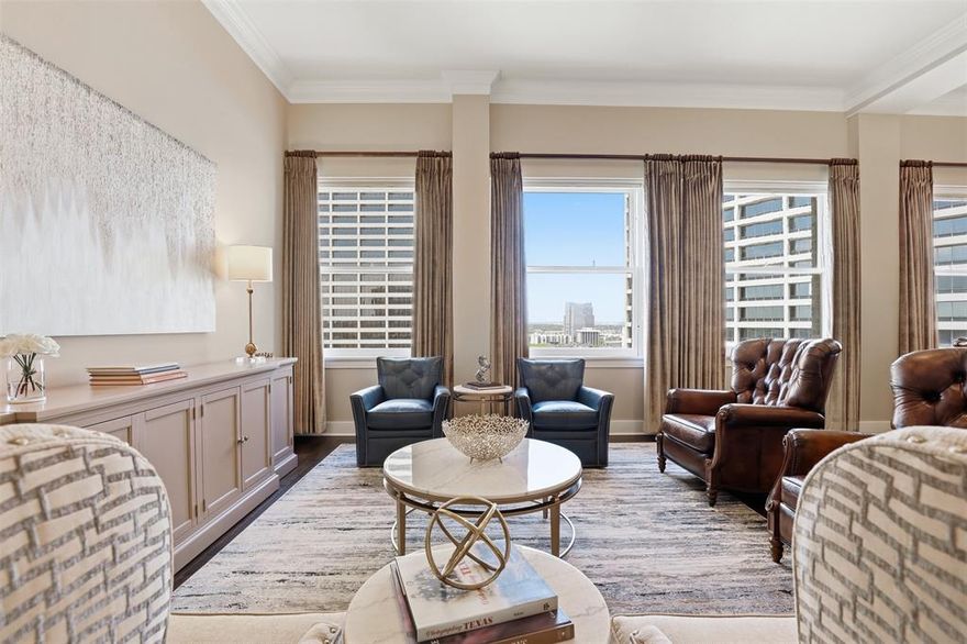 This exceptional residence combines historic charm, refined updates and an unbeatable location in the heart of Fort Worth.  Open spaces filled with light showcasing spectacular sunsets and city vistas. Residence #1005 in the historic Neil P. Anderson Building offers a rare blend of Fort Worth heritage and modern urban living, ideally positioned overlooking Burnett Park. Originally built in 1921 as the Cotton Exchange of Fort Worth, this iconic building now serves as one of downtown’s most distinctive residential addresses—where character and contemporary comfort meet. Spanning over 2,300 square feet, this expansive 2 Bedroom, 2.5 Bath condo features 12 ft ceilings, New Wood Flooring, Ceiling speakers connected to Nuvo Sound System in living area, crown mouldings throughout, split bedrooms, and anchored by a dramatic wall of original windows filling the space with natural light. A stunning kitchen renovation, highlighted by Taj Mahal quartzite countertops, Bosch appliances, a gas cooktop, walk in pantry & updated lighting. The Spacious Primary Suite is a corner location of the building with amazing views & natural light from windows along the front & side of the room, & Built in 30 Drawer Cabinet System. Both bathrooms have been fully transformed with designer finishes, including beautifully appointed showers & tub, along with distinctive glass lavatory sinks accented by elegant underlighting. A dedicated office space offers custom cabinetry, dual desk workstations, a full bookcase wall, complemented by rich emerald granite desktops. Just off the office, a spacious private patio with a retractable awning creates an inviting outdoor retreat—perfect for relaxing or entertaining. The building amenities include a pool deck, dining and outdoor living space, outdoor kitchen & lovely owners lounge. Walk just outside your door to great dining, entertainment and business centers & public transportation including Trinity Rail to DFW Airport . Texas History Meets Urban Living!