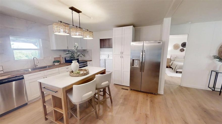 As you walk inside, you’re immediately struck by how open and refreshed the space feels. The kitchen has been completely updated with brand-new shaker-style cabinets in a crisp white finish, complemented by modern light fixtures and a full set of matching appliances that bring everything together, giving it the feel of a site-built home. The living area flows seamlessly from the kitchen, with stylish lighting and new energy-efficient windows that fill the space with natural light.

The bathrooms have been fully renovated with new vanities, mirrors, updated lighting, and clean, contemporary fixtures. Showers and tubs have been upgraded with tile surrounds, adding a polished, upscale touch.

And to top it off, this home offers a new roof.

Overall, it feels nothing like an older mobile home—it’s modern, comfortable, and thoughtfully redesigned from top to bottom, essentially a brand-new home within the existing structure.