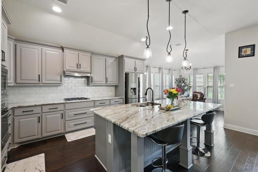 Stunning like new single story that effortlessly blends modern elegance with everyday comfort. Nestled in one of the areas most sought after neighborhoods, this property stands out with exceptional curb appeal and thoughtful after-build enhancements that elevate the home. Pristine engineered hardwood floors, high ceilings, high level granite counters, custom backsplash, designer pendant lights, upgraded primary bathroom with added access to laundry through primary closet. Extended kitchen and primary bedroom. Split bedroom floor plan. Ask your agent for Upgrades List! This one will show like a model with that new construction smell, look, and feel! Seller's pride reflects this beauty.