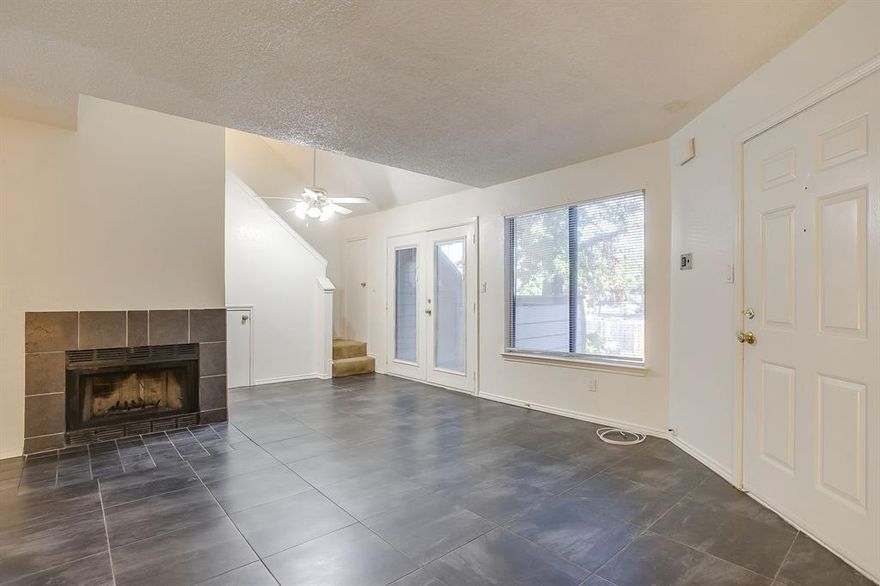 This beautifully updated 2-bed, 1-bath condo offers open-concept living with vaulted ceilings, abundant natural light, and a cozy wood-burning fireplace. The modern kitchen features ample cabinet space and flows seamlessly into the dining and living areas, perfect for entertaining. A spacious loft provides flexibility for a home office or secondary bedroom. Enjoy two private balconies and a tranquil location near the community pool, fitness center, and clubhouse. Conveniently located minutes from Highway 360, shopping, restaurants, and entertainment at AT&T Stadium and Globe Life Field.