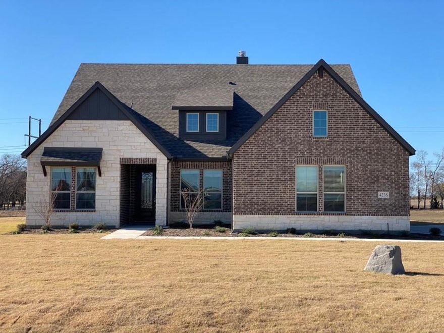 Upon entering the home off the front porch, you’re welcomed by an inviting foyer. Immediately to the left is a hallway with a bedroom, walk-in closet and full bathroom, as well as a linen closet. Across the foyer is a flex room, perfect for a home office, formal dining room or whatever need your family has for the space. Past the foyer is the family entry, with storage space and mud bench, which leads to the laundry room and two or three car attached garage. Through the entrance, the home opens up to a large family room with a stately fireplace. Adjacent to the family room is a gourmet kitchen, equipped with a walk-in pantry, ample counter space and an oversized island. Finishing off this open-concept living area is a dining space which overlooks the covered back patio. The back corner of the home offers privacy for the owner’s suite, featuring a massive walk-in closet and bathroom with a dual-sink vanity, standalone soaking tub and glass-enclosed shower.