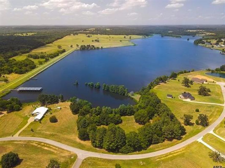 Design your dream home on this vast waterfront property spanning over 2 acres in WATER’S EDGE RANCH. Situated in rolling hills adorned with lush trees and a peaceful 328-acre lake, this gated community encompasses 2,150 stunning acres. Each plot was meticulously designed to provide ample space and breathtaking views. Embrace the life of country living in a serene, secure setting just minutes to the conveniences of urban amenities.   enjoy easy access to the resort pool and boat launch just a short walk away. your private sanctuary with approximately 200 feet of waterfront is just a simple phone call away.  imagine a lifestyle away from the city's hustle and bustle…what more could you ask for?