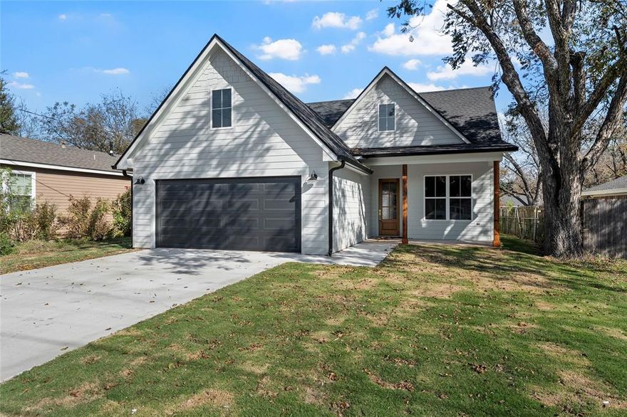 This thoughtfully designed 1,906 sq. ft. home offers timeless style with 3 bedrooms, 2 bathrooms, and a spacious 2-car garage. Step inside to an open concept layout where the kitchen, dining, and living areas flow seamlessly together. The kitchen stands out with a large island accented in a calming green tone, custom cabinetry, warm white quartz countertops, and a full slab quartz backsplash. Throughout the home, you’ll find elegant brushed gold-champagne bronze fixtures, cabinet hardware, and plumbing accents that add a refined touch. Durable light-to-medium oak look LVP flooring carries through the main areas, while the bathrooms feature matte porcelain tile in a warm light gray- cream. Showers are finished in classic 4x12 off-white subway tile for a clean and timeless look. A convenient mudroom leads into a very large laundry room, complete with custom green cabinetry and dedicated space for stand up freezer or spare fridge. The two spare bedrooms offer oversized closets, while the private primary suite features a huge walk-in closet, dual vanities with coordinating finishes, a soaking tub, and a separate fully tiled shower. Energy efficiency is built in with spray foam insulation for year-round comfort and lower utility costs. Walls throughout the home are painted a soft off-white, creating a serene backdrop that highlights the tasteful design choices. Outside, enjoy a covered back patio perfect for relaxing or entertaining. With custom finishes, carefully curated details, and a functional floor plan, this brand-new West home is ready to welcome its first owners.