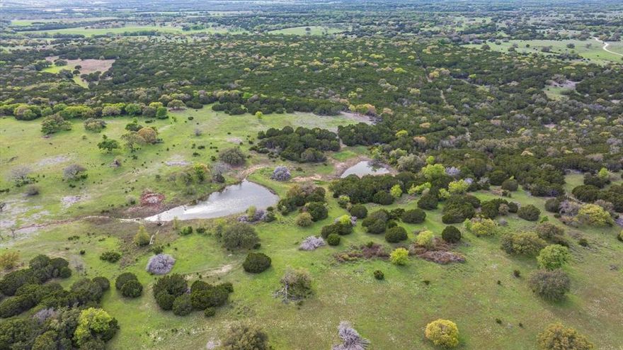This 200-acre tract is for sale, situated approximately 5 miles away from Meridian, Texas. This property offers an ideal blend of seclusion and proximity to modern amenities. This property boasts rolling terrain and expansive views, making it a perfect location for those seeking a picturesque landscape. The seller has cleared the property selectively, providing access to almost all boundary lines. With several building sites available, complete with large oak trees, this property is perfect for those who want to build their dream home. You can watch a video to see how beautiful this property truly is. Hunters will appreciate the recently carved-out senderos, which provide better accessibility and create an ideal habitat for various wildlife species. The property features two stock tanks, and the Gibson Branch transverses on the east side. A variety of hardwoods and cedar contribute to the property's natural beauty.