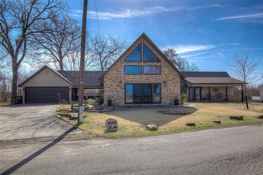 Experience the ultimate resort lifestyle in this stunning 3-bedroom, 3-bathroom A-frame home, perfectly situated directly behind the #3 green at the prestigious Sulphur Springs Country Club. This unique residence offers unparalleled views of the manicured fairways and the tranquil lake, with a west-facing orientation that guarantees breathtaking sunsets every evening. Having been cherished by the same family for 30 years, the home has been thoughtfully updated to blend modern luxury with timeless comfort. The heart of the home is the gourmet kitchen, which features soaring cathedral ceilings, high-end KitchenAid appliances, and custom real wood cabinetry that extends throughout the entire house.
The interior layout is designed for entertaining featuring brand-new flooring across the main level and impressive cathedral ceilings in the living room. Comfort is paramount with cozy propane gas fireplaces located in both the living room and the primary suite. The primary bathroom has been completely redone to provide a spa-like retreat, while the versatile floor plan includes a dedicated office and full bedroom downstairs, plus an expansive A-frame bedroom and bathroom upstairs. Practicality meets luxury outdoors with two separate garages for automobiles and golf carts, a newly built RV cover, secure metal fencing, and a covered porch with an outdoor cabinet for your television. With immediate access to the practice range, lake, and club facilities, this home is ready for its next family to begin building a lifetime of memories in a setting that feels like a permanent vacation.
Agent is owner.