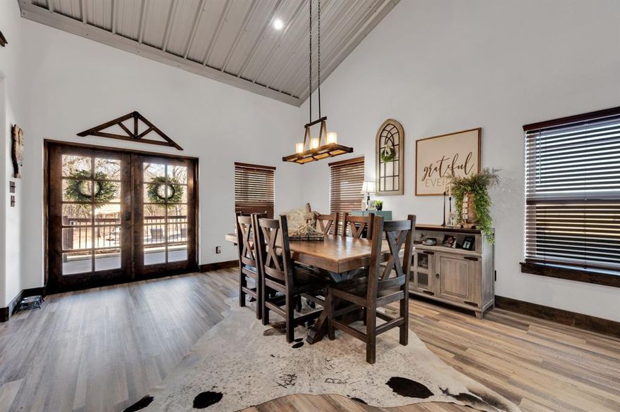 Indulge in refined country luxury at this extraordinary barndominium estate, gracefully set on just under four breathtaking acres at 9824 County Road 305 in Grandview, within the highly acclaimed Grandview Independent School District. Perfectly positioned between Waco and Fort Worth, this remarkable property offers the serenity of small-town living without sacrificing convenience. This is the one you’ve been waiting for — where timeless luxury meets the freedom of wide-open spaces.  Immaculately maintained and designed for both comfort and sophistication, the main residence showcases 3 spacious bedrooms, 2.5 baths, a dedicated office, and two expansive living areas. Inside, a majestic wood-burning fireplace anchors the home with warmth and grandeur, creating an unforgettable focal point for gatherings and cozy evenings alike. Generous attic storage provides exceptional functionality without compromising living space.  Step outside into a private resort-style retreat where luxury and leisure meet. The sprawling outdoor living area is an entertainer’s dream, featuring a stunning outdoor fireplace, grilling space, relaxing hot tub, and a sparkling pool — all surrounded by towering trees and sweeping views of your horse pasture and barn. Whether hosting lively celebrations or enjoying peaceful Texas sunsets, this outdoor sanctuary delivers an unparalleled lifestyle experience.  The impressive shop includes beautifully appointed detached guest quarters complete with a private bedroom, full bath, and comfortable living area — ideal for extended family, guests, or multi-generational living.  From the equestrian amenities to the exquisite indoor and outdoor living spaces, this one-of-a-kind property embodies luxury country living at its finest. Rarely does a home offer this level of privacy, elegance, and versatility in such a prime location.  Come experience a place where sophistication meets wide-open spaces — and where every detail invites you to stay.