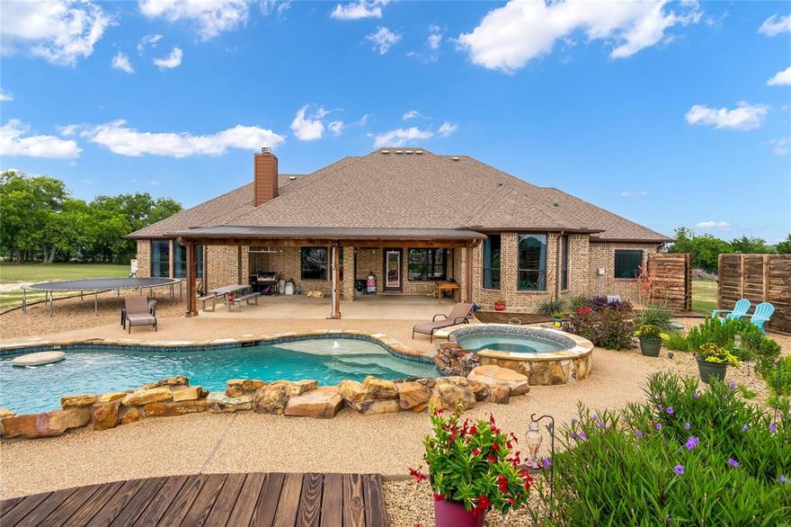 MULTIPLE OFFERS! Please submit highest and best by Sunday 6.25 at 9pm! Exquisite custom home situated on 2.4 acres in the county, saving on property taxes and no HOA. Foyer leads to the open living space with stone fireplace and hand scraped wood floors. The tall windows allow natural light and highlight the amazing backyard. With high-end finishes throughout, the spacious kitchen serves as the heart of the home and is perfect for family gatherings &amp; entertaining guests. The primary suite is it&#39;s own private oasis complete with views of the gorgeous backyard. En-suite bath features a double shower and jetted tub as well as massive walk-in closet that leads to laundry room for added convenience. Additional primary suite is spacious with it&#39;s own full bathroom. Backyard is a DREAM with large covered patio, gorgeous landscaping, heated pool and hot-tub with waterfall features, a grotto and slide. Truly one-of-a-kind, this property is an absolute showstopper. See transaction desk.