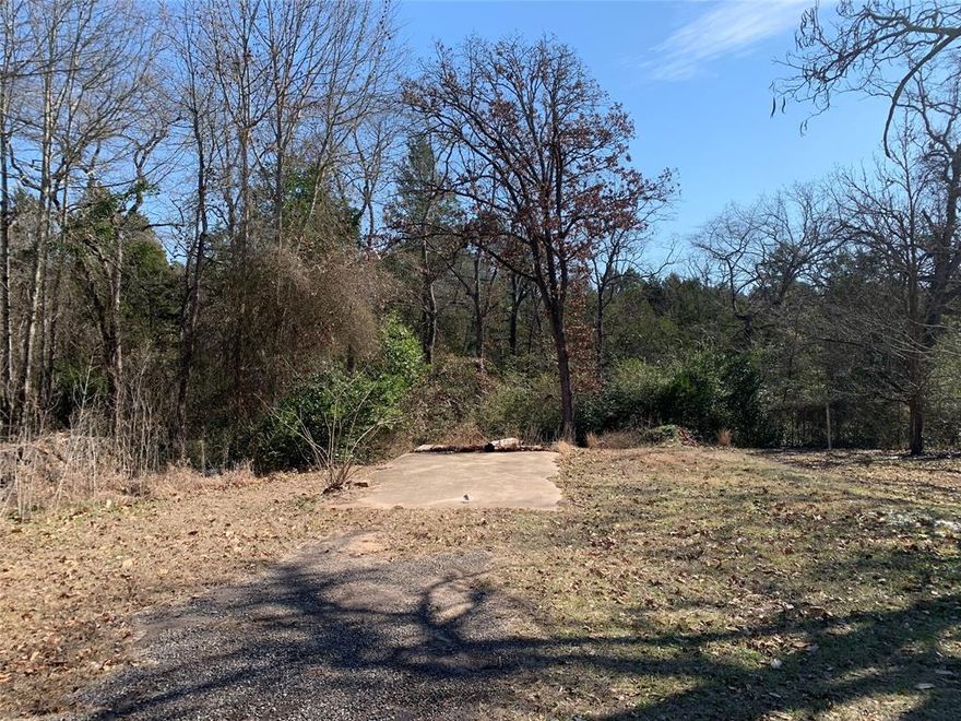This .8-acre wooded lot inside the city limits offers an ideal setting for your dream home. With utilities available at the road, this property features rolling terrain, mature trees for natural privacy, and a small creek. You can build near the road for easy access or at the elevated back portion of the property for ultimate seclusion. Conveniently located near Bel Air Elementary and the hospital, this tract provides both privacy and in-town convenience. Bring your plans and make it your own! No mobile homes permitted.