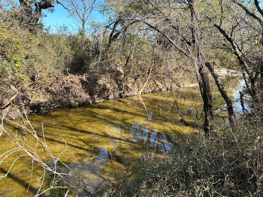Discover a Texas treasure in Coryell County with this 151.67-acre ranch, a blend of natural splendor and agricultural potential, making it a great combination ranch. It features year-round Plum Creek, five ponds, and several seasonal creeks, creating a serene and resource-rich environment. The property boasts high fencing along the south and west, with extensive FM 2412 frontage. A fertile 35-acre field near Plum Creek enhances its appeal. Ready for a cattle operation, it's cross-fenced with commercial quality cattle pens. Accommodations include a 2-bedroom, 1-bath fixer-upper farmhouse, and a modern 2-bedroom, 1-bath barndo, offering comfortable living. Additional structures like a barn and equipment shed provide ample storage. This unique find is ideal for those seeking the country lifestyle or a thriving ranch in Central Texas.