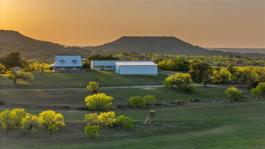 The Pennington Ranch spans approximately 935.87 high-fenced acres of scenic, rolling terrain located just 9 minutes northwest of Comanche, TX. This premier recreational and hunting property features a diverse mix of mature oaks, cedar elm, native brush, and improved pastures, offering exceptional wildlife habitat and panoramic views.

The ranch includes 9 contiguous parcels with approximately 1.65 miles of FM 1689 frontage and 0.57 miles along CR 103. Elevation ranges from 1,460’ to 1,610’ ASL, with gently rolling topography throughout. Surface water is abundant with 10+ stock tanks, two large 2+ acre ponds, and seasonal Duncan Creek crossing the southeastern portion.

Improvements sit on one of the highest points of the ranch and include a 1,966 SF main residence (3BR,2BA, metal roof, wraparound porch), a detached 2-car garage with breezeway, a 1,209 SF guest apartment, two 455 SF equipment garages, a large 1,857 SF covered shed, an additional 2,500 SF equipment shed, and an 867 SF livestock barn with working pens.

Water is supplied by two wells near the main improvements, with three additional windmill wells that may be reworked. Electricity is provided by CECA and is accessible throughout the ranch. The property also includes improved food plots, ample edge habitat for wildlife, and is home to native game like whitetail deer, turkey, hogs, dove, and a few exotics.

With stunning views, excellent infrastructure, and a blend of recreational, agricultural, and residential appeal, Pennington Ranch is a rare offering in the heart of Comanche County.